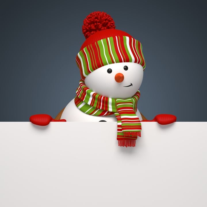 A cheerful snowman peeks over a blank white sign, wearing a red and green striped hat and scarf against a dark background.