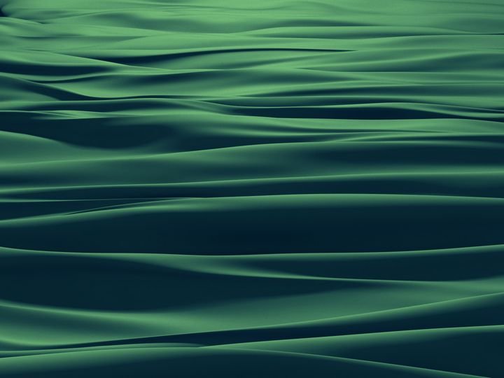 Wavy green fabric ripples across the frame, showcasing smooth textures and fluid motion.