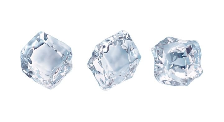 Three clear ice cubes float against a white background, showcasing their crystalline texture and transparency.