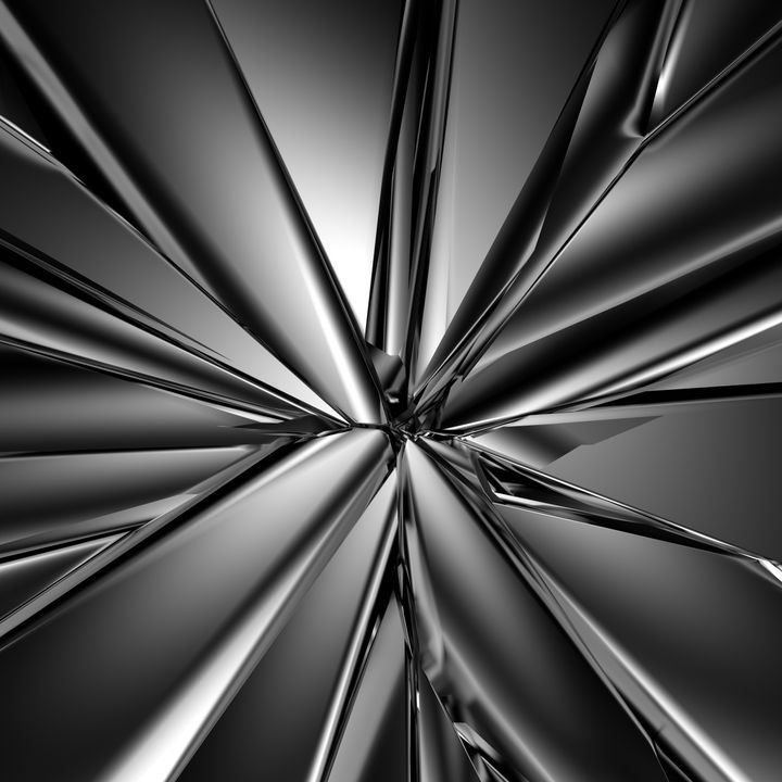A metallic, abstract design radiates from a central point, creating sharp, reflective rays.