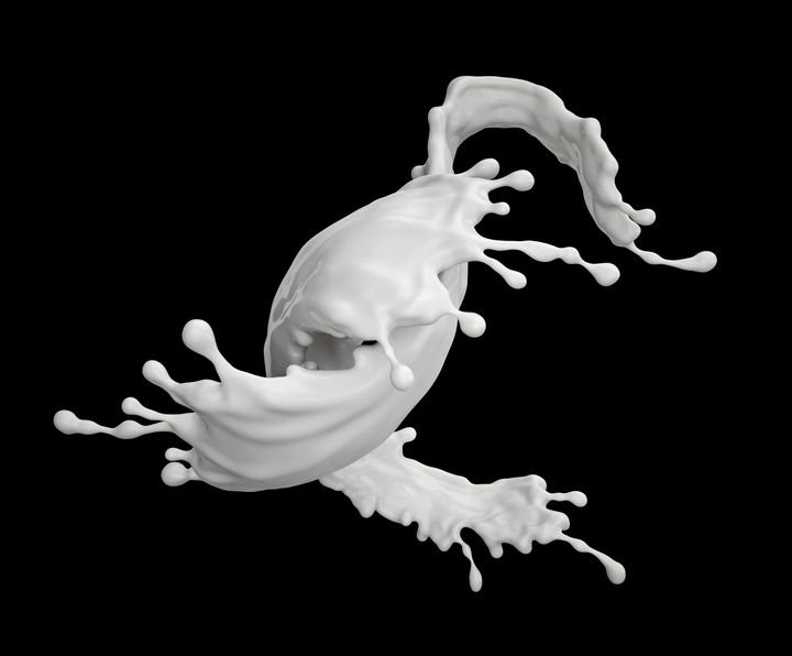 A dynamic splash of white liquid freezes mid-air against a stark black background, capturing motion and texture.