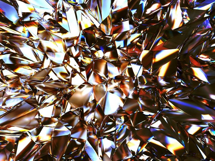 Shiny, fragmented glass pieces reflect light in a chaotic, colorful mosaic.