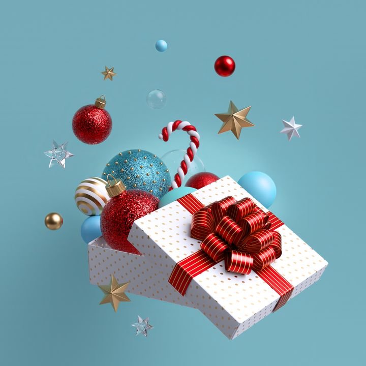 3d Christmas ornaments and glass balls falling out, open white wrapped box with red bow. Winter holiday package. Levitating objects. Festive clip art isolated on blue background