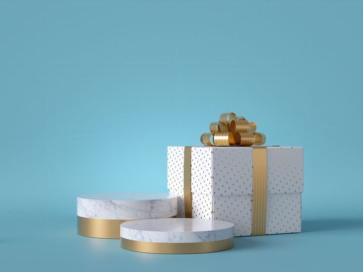 3d wrapped Christmas gift isolated on blue background. White square box with golden bow. Round marble podium, blank pedestal steps, empty space. Cylinder platform. Product showcase mockup.