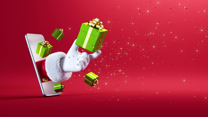3d Christmas animation. Cartoon character Santa Claus hand appears from the mobile phone screen and holds green gift box, festive ornaments levitate, golden confetti falls down on the red background