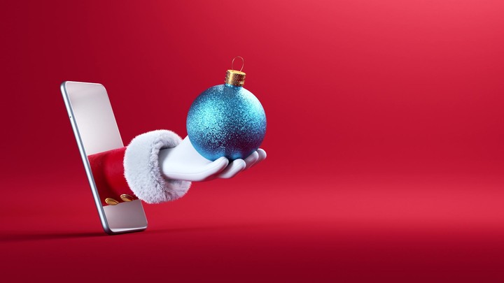 3d render. Cartoon character Santa Claus hand appears from the smart phone screen and throws up blue glass ball ornament. Christmas animation with red background