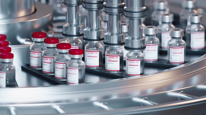 Automatic process of Sars-COV-2 COVID-19 coronavirus vaccine mass production. Machine puts red caps on glass bottles moving on pharmaceutical conveyor belt. Endless 3d animation, repeating action