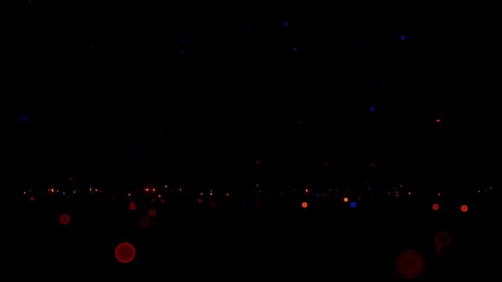 3D animation. Abstract festive background. Blue, red, and gold sparks in the dark, sparkling like glitter, whirling and fading, creating a magical atmosphere
