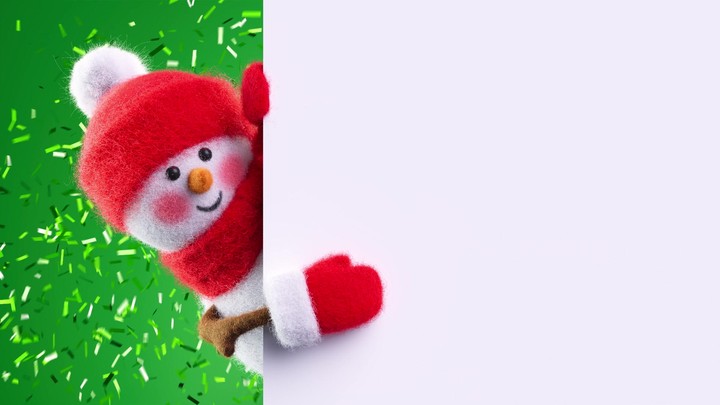 Needle‑felted wool snowman peeks from behind a white banner as green confetti pops in the background. Cheerful Christmas or New Year clip.